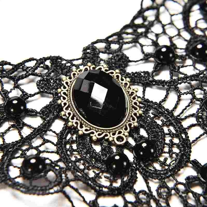 Close-up detail of steampunk choker central decoration showing intricate lace weave, oval black gemstone, and ornate bronze frame
