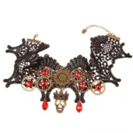 Steampunk lace choker flat lay showcase featuring black lace, bronze gears, red crystals, and crowned skull pendant on white background