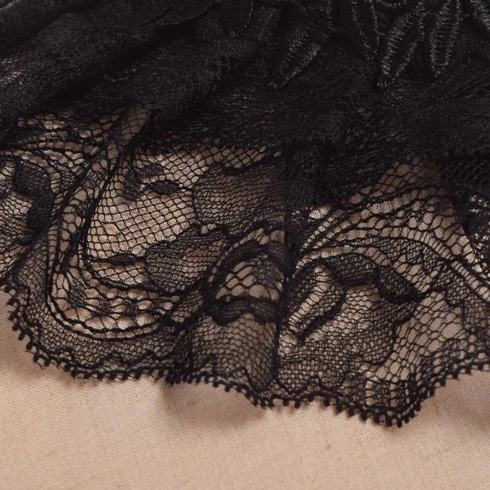 Intricate black floral lace texture close-up of steampunk choker showing scalloped edge and sheer layered mesh weave