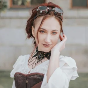 Gothic steampunk lace choker worn by model in Victorian steampunk outfit with goggles, outdoor fashion photography