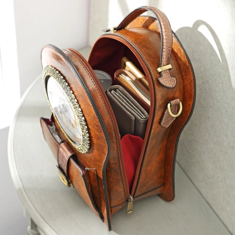 Opened steampunk clock crossbody bag interior revealing red lining, internal storage compartments, working clock mechanism, and organized pocket design