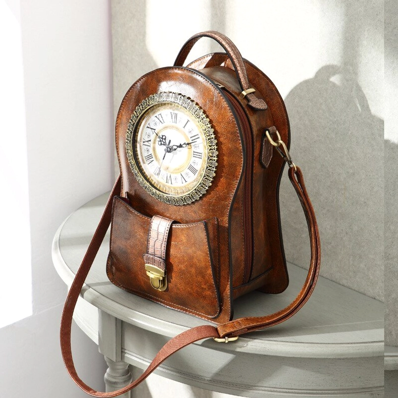 Vintage steampunk leather clock bag displaying adjustable shoulder strap with metal adjusters, decorative clock ornament, and side angle profile showcasing crossbody design