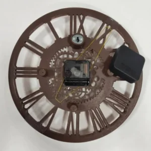 Steampunk wall clock rear view showing dark brown back panel, quartz clock movement kit, AA battery compartment, and keyhole wall mounting system