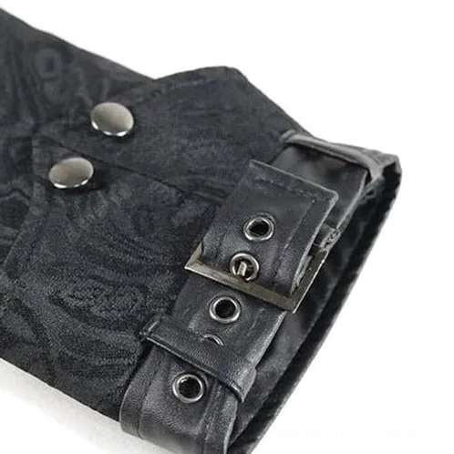 Steampunk coat cuff fastening close-up showing leather buckle straps, metal snap fasteners, metal eyelets, and dark patterned fabric construction