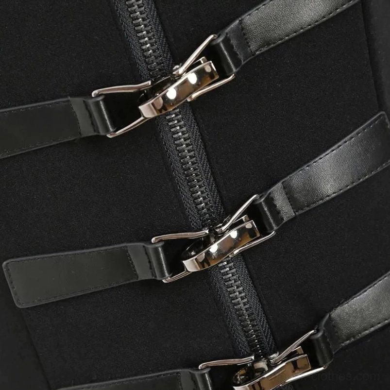 Close-up detail of steampunk coat hardware - silver metal zippers and black leather buckles on matte black fabric