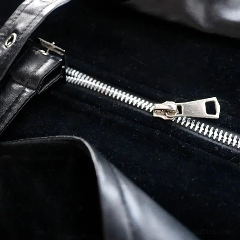 Silver metal zipper slider and teeth close-up on black velvet steampunk coat