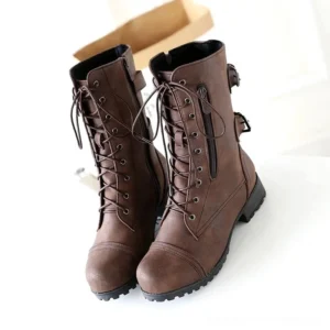 Women's steampunk lace-up combat boots with decorative buckles, front three-quarter view showing brown faux leather, side zipper, and lace closure