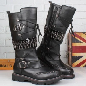 Black steampunk leather combat boots with side zipper, metal buckles and spike band against industrial brick wall backdrop