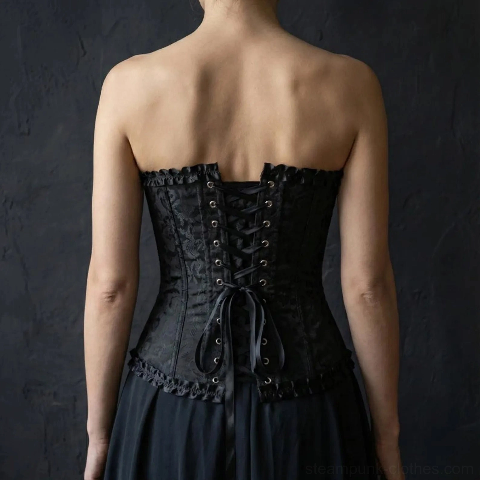 Overbust steampunk corset back view showing adjustable lace-up closure and ruffled hem detail with intricate brocade pattern