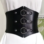 Black steampunk corset belt with silver O-rings and rivets displayed on dress form, close-up front view showing detailed faux leather construction and industrial metalwork detailing