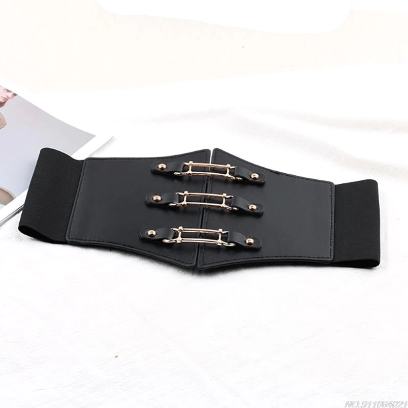Black steampunk corset belt flat lay featuring three golden metal buckles, split-front closure design, elastic side panels, and full belt length on white background