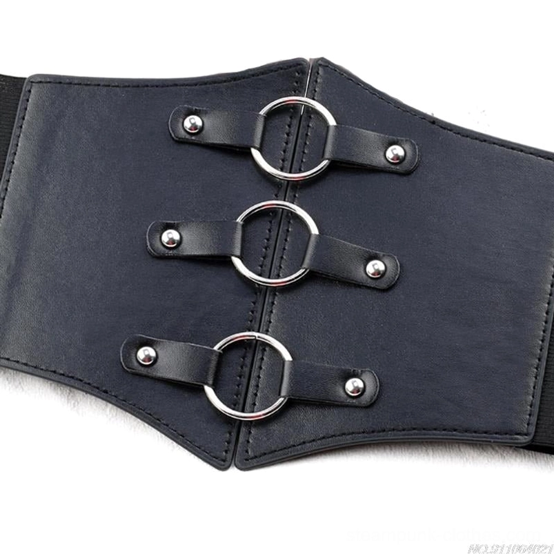 Gothic corset waist belt flat lay close-up showing smooth black faux leather surface with three silver O-rings and industrial hardware rivet detail