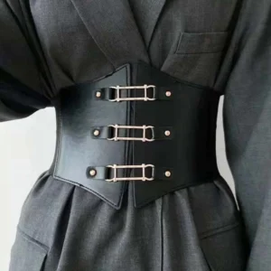 Black steampunk corset belt with three golden metal buckles worn over gray formal suit, front view showcasing split-front leather design, elastic band construction, and cinched waist silhouette