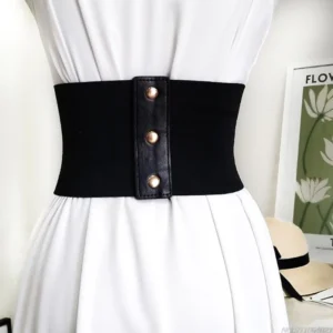 Close-up front view of steampunk waist belt featuring elastic side panel construction, metal snap button closure mechanism, and laced corset-style front detail on dress form wearing white dress for styling reference
