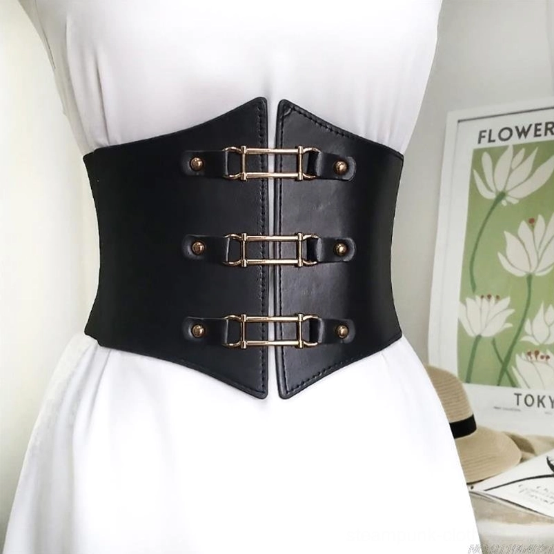 Black leather steampunk waist belt with triple golden buckles and decorative metal hardware displayed on dress form wearing white dress, demonstrating front closure system and premium leather texture