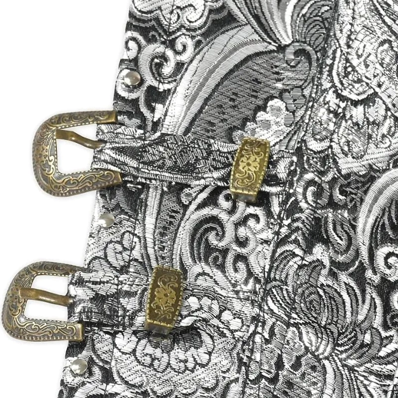 Close-up detail of steampunk corset brass buckles, metal rivets, and paisley jacquard fabric
