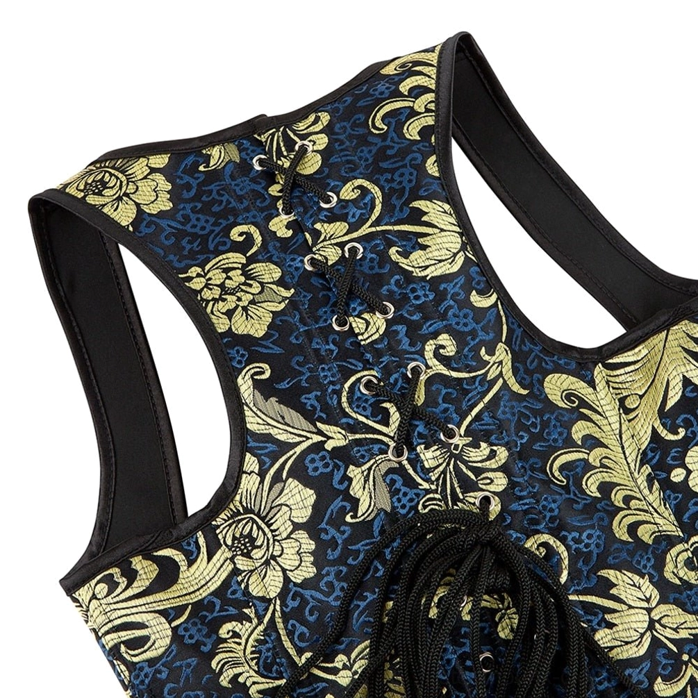 Close-up detailed view of steampunk corset brocade floral pattern with gold metallic detailing on dark fabric, black shoulder strap visible, demonstrates craftsmanship