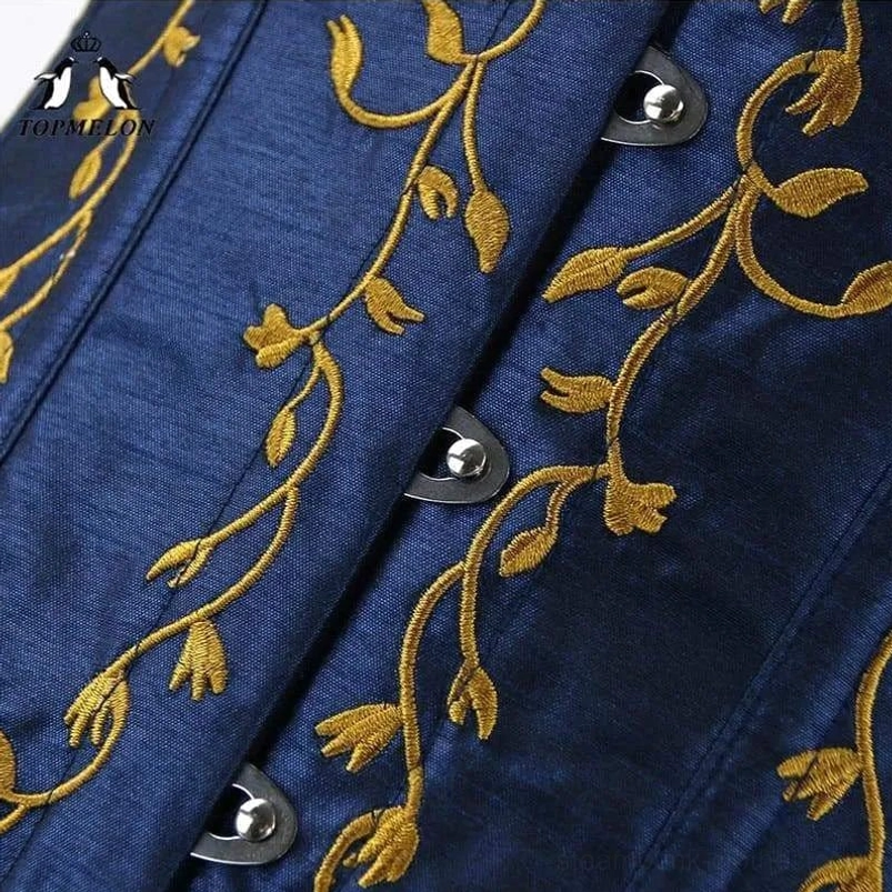 Close-up macro shot of steampunk corset fabric showing dark blue satin texture with gold floral embroidery and metal hook fasteners