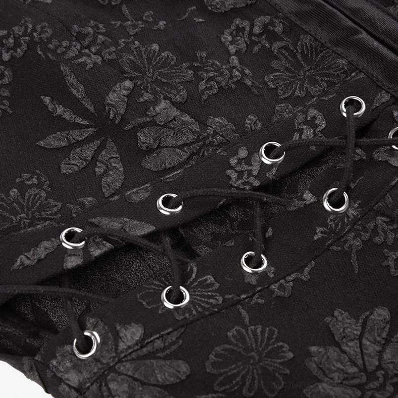 Macro close-up of black floral jacquard fabric texture with metal eyelets and lace-up drawstring fastening system