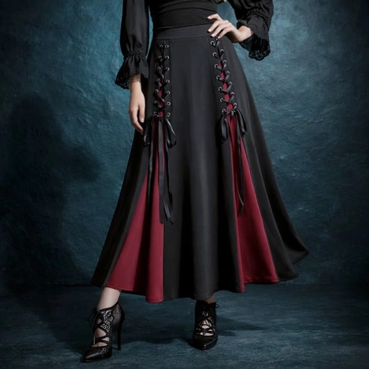 Black and burgundy steampunk A-line skirt with dual corset lace-up detailing, worn on model showing high-waisted silhouette and gothic color-blocking