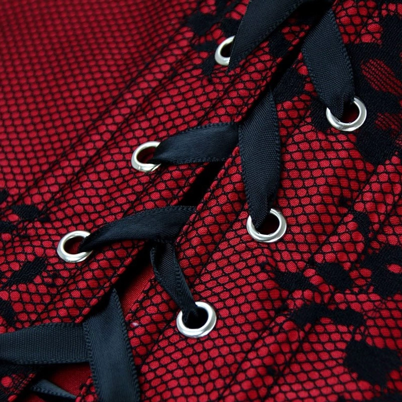 Corset back lace-up construction detail with black ribbon lacing and metal grommets on red mesh base