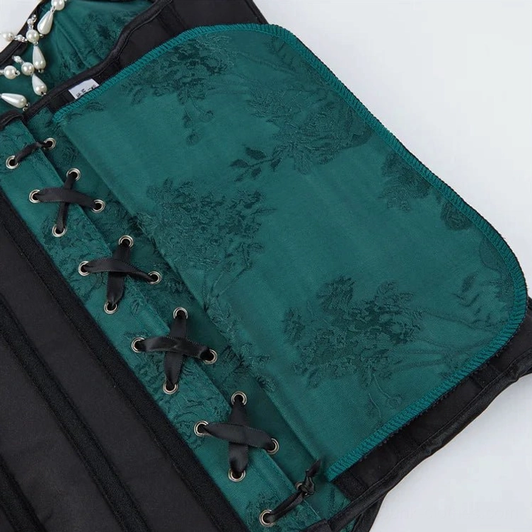 Green floral jacquard corset lace-up panel detail with black ribbon ties and dark fabric pattern
