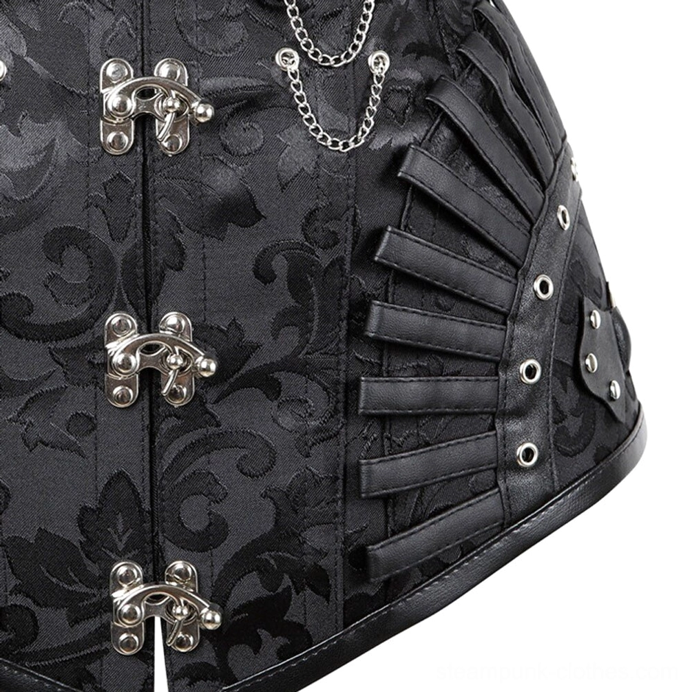 Close-up detail of steampunk corset side showing fan-shaped leather strips, metal eyelets, silver hardware, and damask jacquard fabric pattern