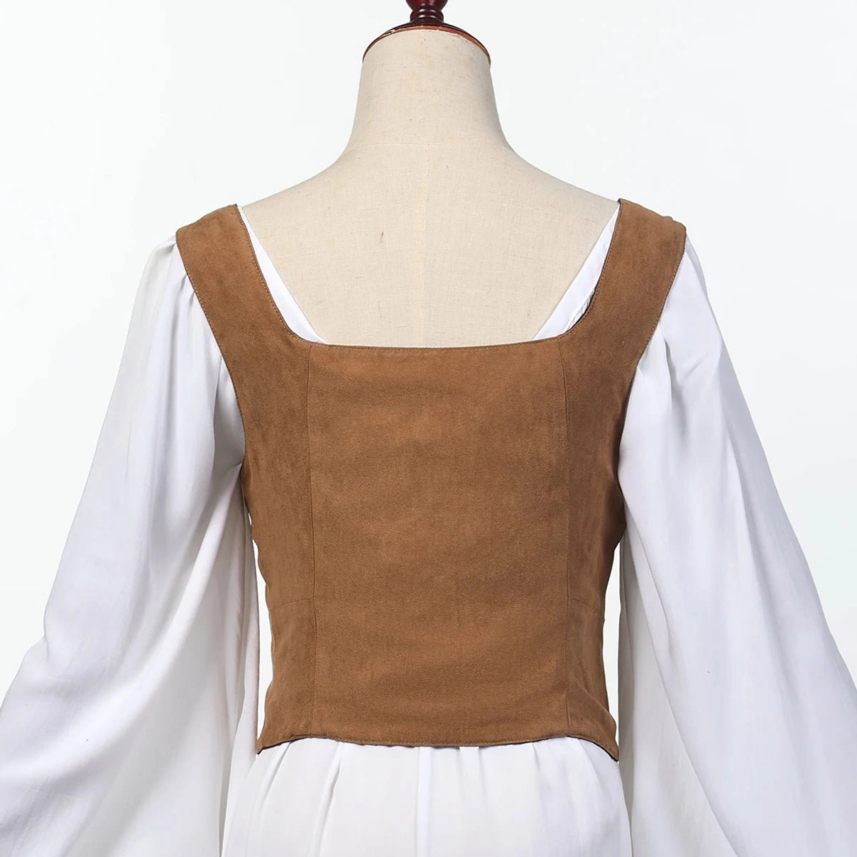 Back view of steampunk corset vest on dress form mannequin displaying square back neckline, tailored waist fit, and light brown suede fabric construction