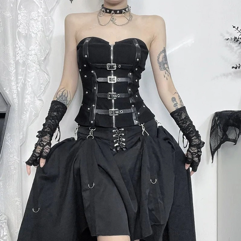 Strapless steampunk corset low front view worn with layered black skirt featuring metal rings and industrial details in white lace studio environment
