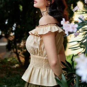 Side profile of beige steampunk blouse with dotted cotton fabric, ruffled trim, and smocked waistline - romantic vintage design