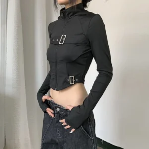 Black steampunk cropped jacket with metal buckle details and exposed waistline, right three-quarter view demonstrating fit