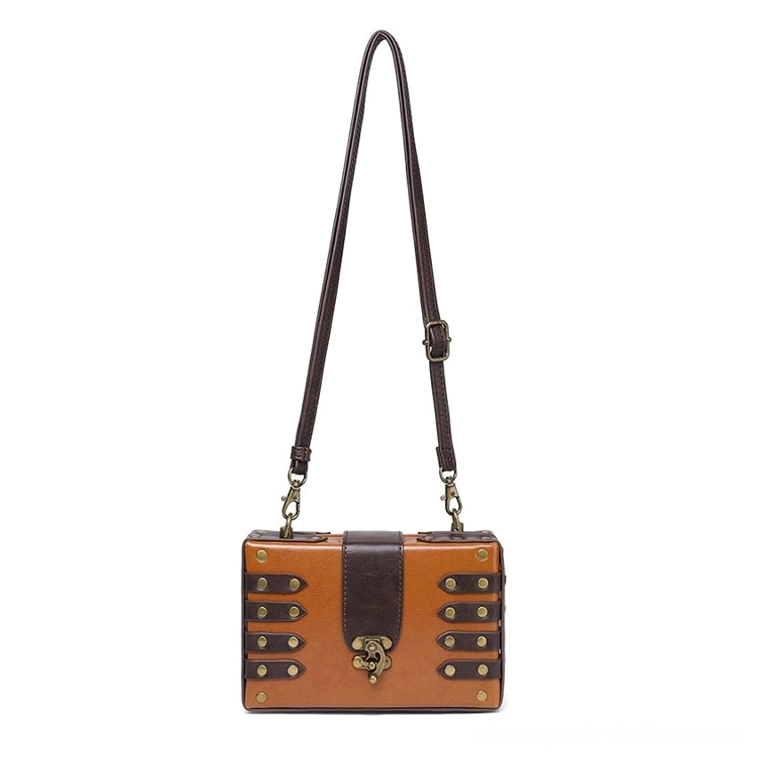 Front hanging display of antique brass rivet steampunk leather bag with full-length adjustable crossbody strap and compact boxy silhouette in dual-tone brown