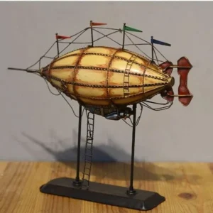 Steampunk dirigible model featuring yellow envelope, red-brown tail rudder, and silver metal gondola on display stand - right side perspective