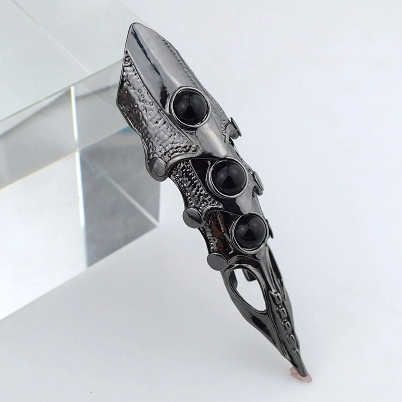 Steampunk dragon finger armor ring side view with gunblack metal finish, three black resin gems, and intricate hollow carved texture details