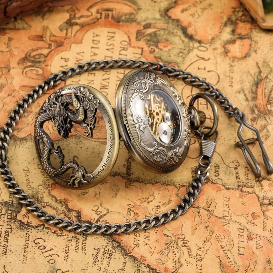 Steampunk dragon pocket watch with metal chain flat lay showing complete timepiece with carved dragon cover