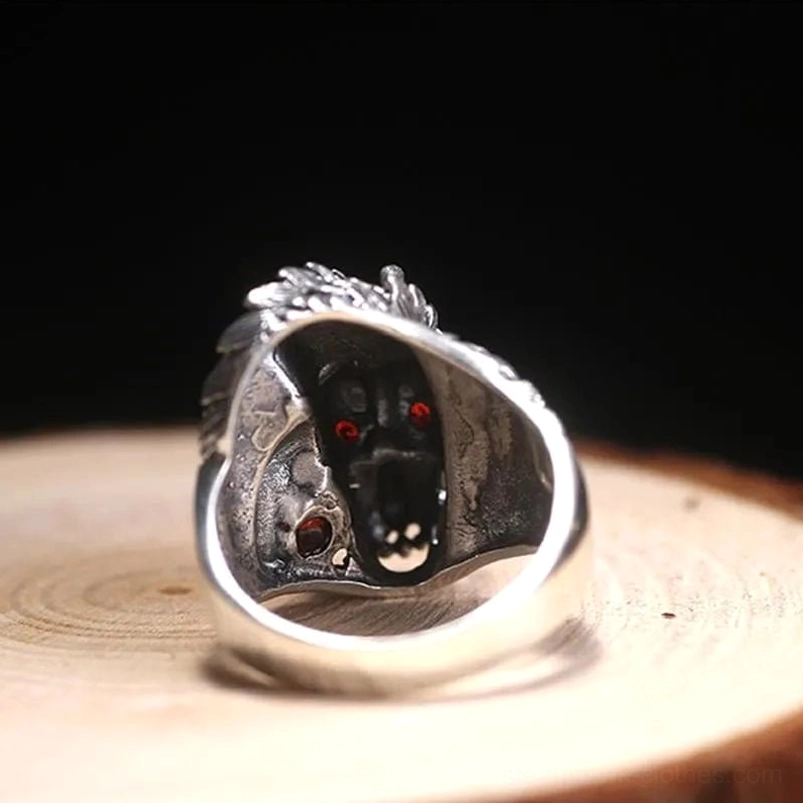 Rear close-up of 925 sterling silver steampunk dragon ring revealing carved interior dragon details and red gem accents on smooth ring shank