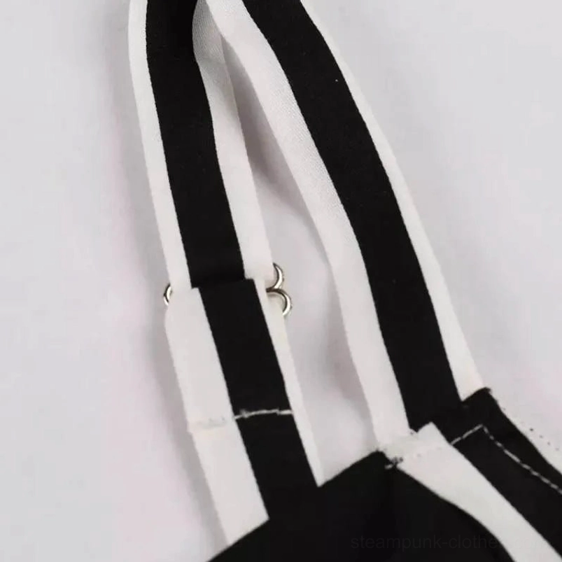 Adjustable spaghetti strap detail with metal adjuster buckles and reinforced stitching on striped steampunk dress, flat lay on white background