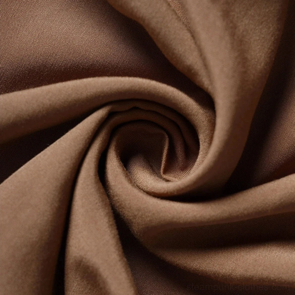 Close-up macro detail of mocha brown steampunk dress fabric showing smooth matte woven texture and soft drape