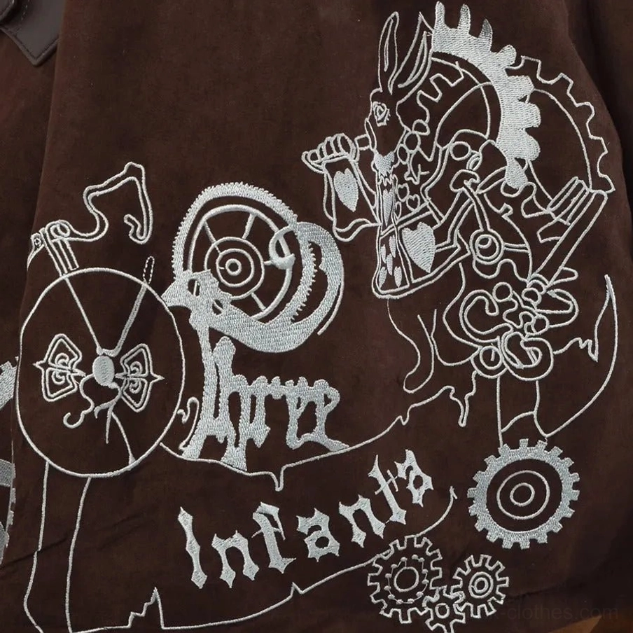 Flat lay close-up of steampunk dress embroidery detail showing silver mechanical gear pattern with artistic rabbit design and 'Infanta' text embellishment