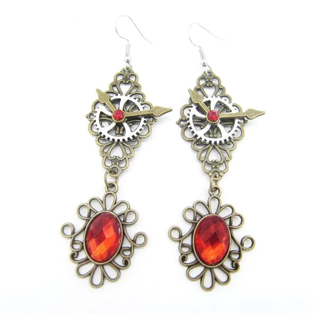 Red gemstone steampunk drop earrings with bronze alloy gears and clock pointer details, front view