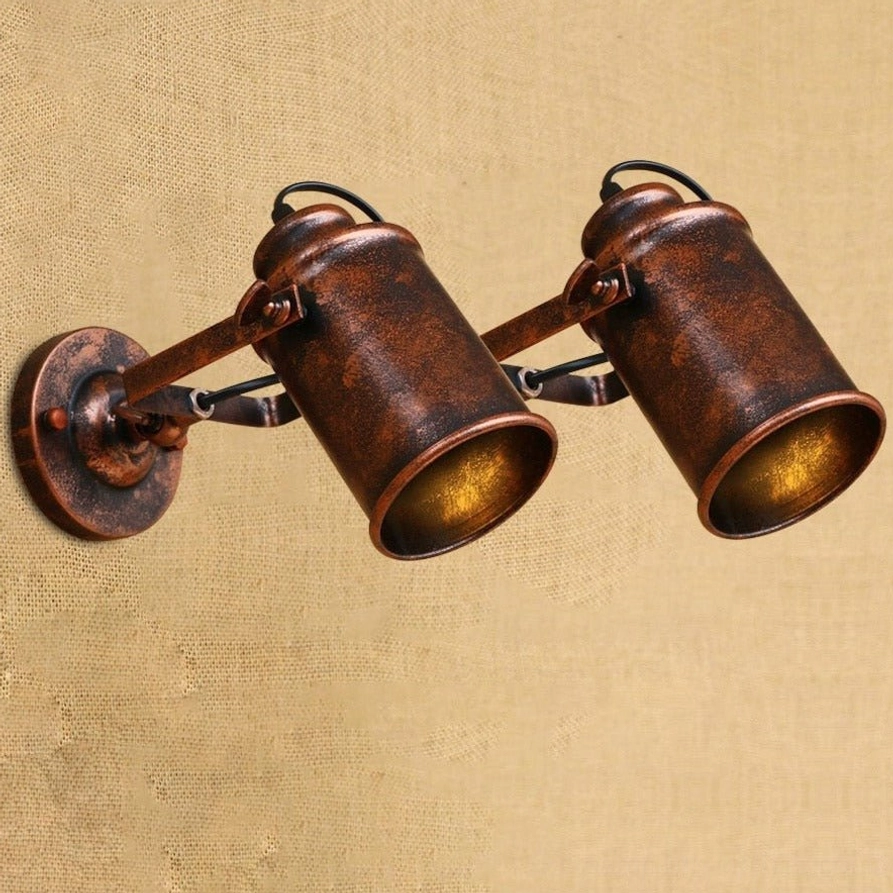Dual-head steampunk wall lamp with adjustable swing arms, distressed bronze iron finish, front three-quarter view showing articulated joints and mechanical design