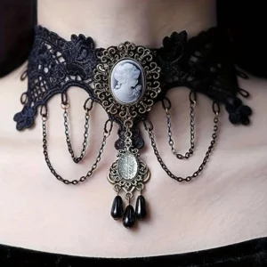 Victorian cameo lace choker with embroidered floral patterns, bronze filigree frame, and dangling black teardrop beads - front close-up detail view