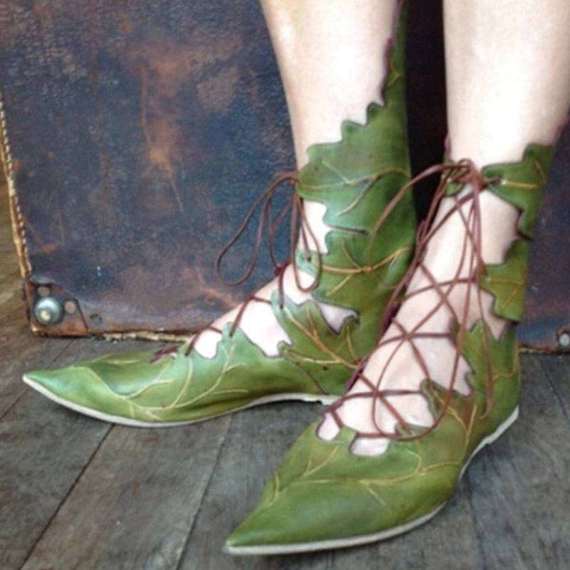 Green elf fantasy flats with brown crisscross lacing and leaf cutout details, side three-quarter angle view