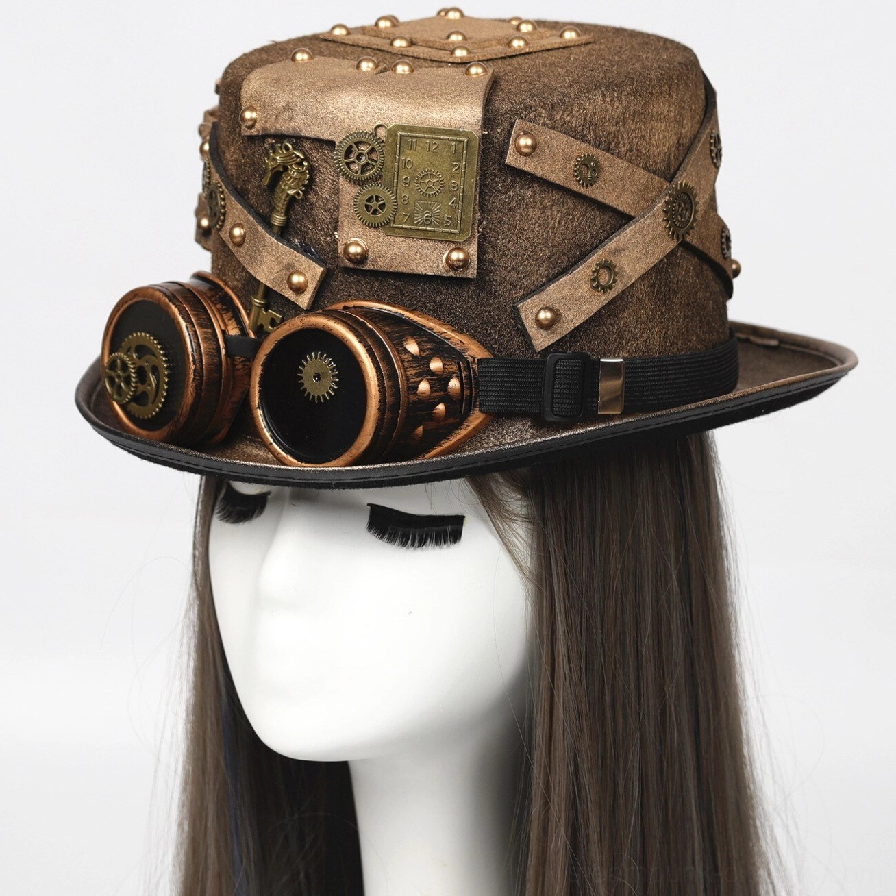 Steampunk explorer top hat with detachable brass goggles, worn on female mannequin, showcasing distressed brown woolen felt, riveted leather straps, and gear ornaments
