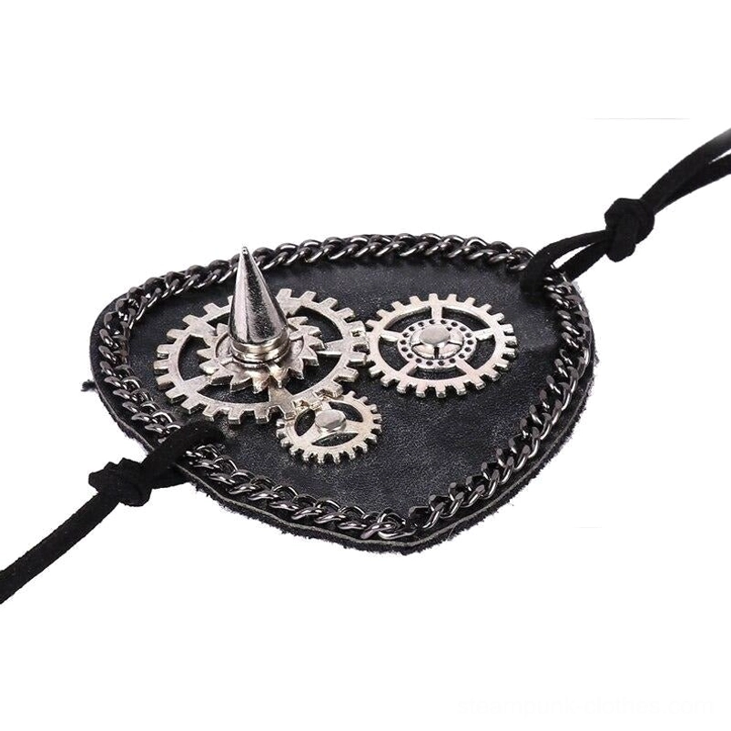 Flat lay front view of steampunk eye mask showing black vegan leather base, intricate silver gears and spike ornaments, black chain border, and adjustable suede strap