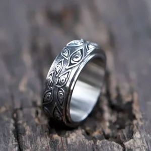 Steampunk all-seeing eye spinner ring - antique silver titanium steel with rotating band and intricate eye carvings, overhead view