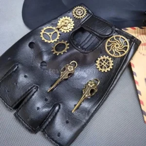 Black fingerless steampunk biker gloves with brass gear and key pendants, flat lay top-down view