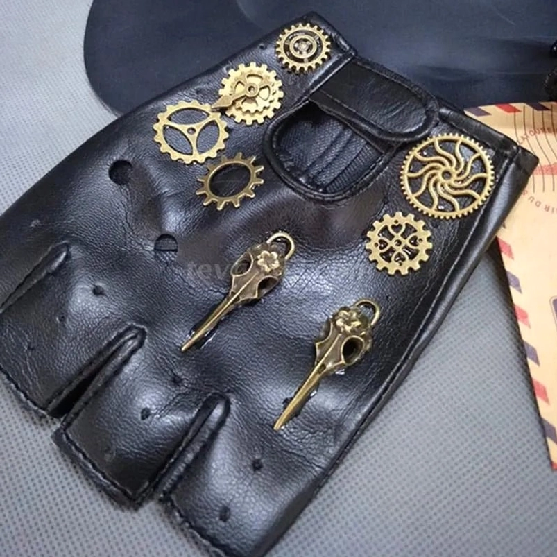 Black fingerless steampunk biker gloves with brass gear and key pendants, flat lay top-down view