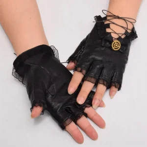 Black fingerless steampunk gloves with golden gear ornament and ruffled lace cuffs on female model hands, front view studio shot