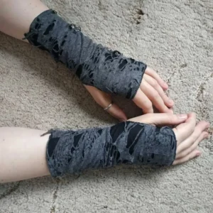 Rebellious steampunk fingerless arm gloves - overhead top-down view showing two pairs of hands wearing dark grey ripped fabric gloves with black inner lining and frayed edges on indoor carpet surface